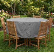 Khomo Gear gray round patio table cover on a table surrounded by wooden chairs on a lawn
