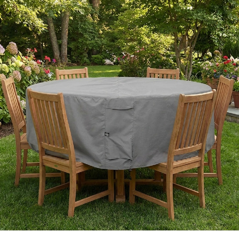 Khomo Gear gray round patio table cover on a table surrounded by wooden chairs on a lawn