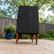 Black - Khomo Gear stackable chair outdoor cover, low-angle front view on the patio