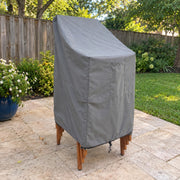 Gray - Khomo Gear stackable chair outdoor cover, three-quarter view on a stack of patio chairs