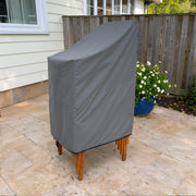Gray - Khomo Gear stackable chair outdoor cover, three-quarter view on the patio