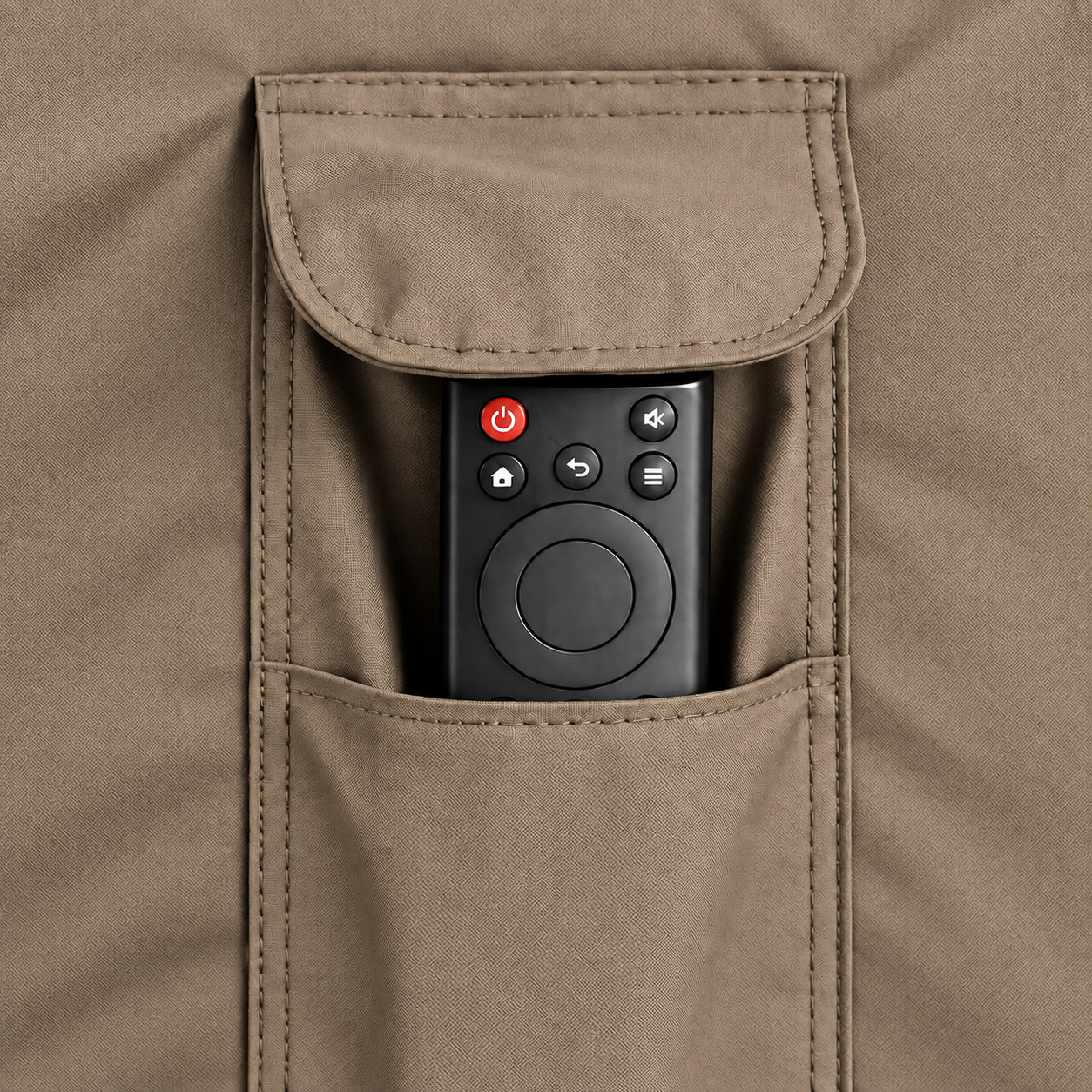 A close-up of a tan fabric pocket containing a black remote control with a red power button.