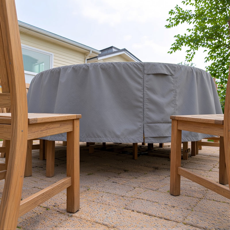 Khomo Gear gray round table cover seen between wooden patio chairs
