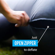 Hand opening the zipper to deflate the Khomo Gear inflatable movie screen