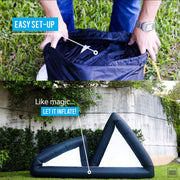 Khomo Gear inflatable screen unpacked from its bag and inflating in a backyard