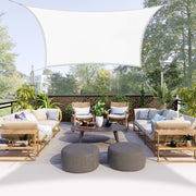 Khomo Gear rectangle shade sail over a patio seating area with outdoor sofas