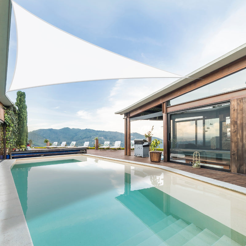 Khomo Gear white triangle shade sail over a pool and patio with mountain views